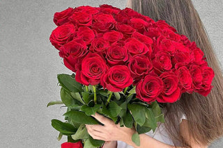 Luxury bouquet of long-stem red roses held by a woman in Los Angeles, premium romantic flowers, Hollywood rose delivery