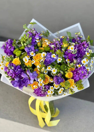 Spring flower bouquet. Wild flowers. Mother's day bouquet. Yellow roses, chamomiles.