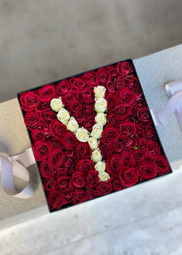 Flowers with initials: square black box of red spray roses with a letter Y in white roses, top view